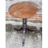 A Georgian mahogany circular occasional table, on tripod base, 22" dia (top damages) and a similar