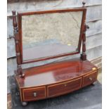 A 19th century mahogany bowfront toilet mirror, on plateau base fitted three drawers, 21" wide