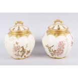 A Royal Worcester blush ivory pot pourri pot and cover and a similar companion, 7 1/2" high