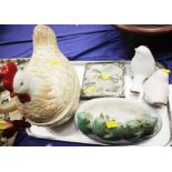 A hen egg crock, two ceramic birds, a duck tile and a group of five frogs