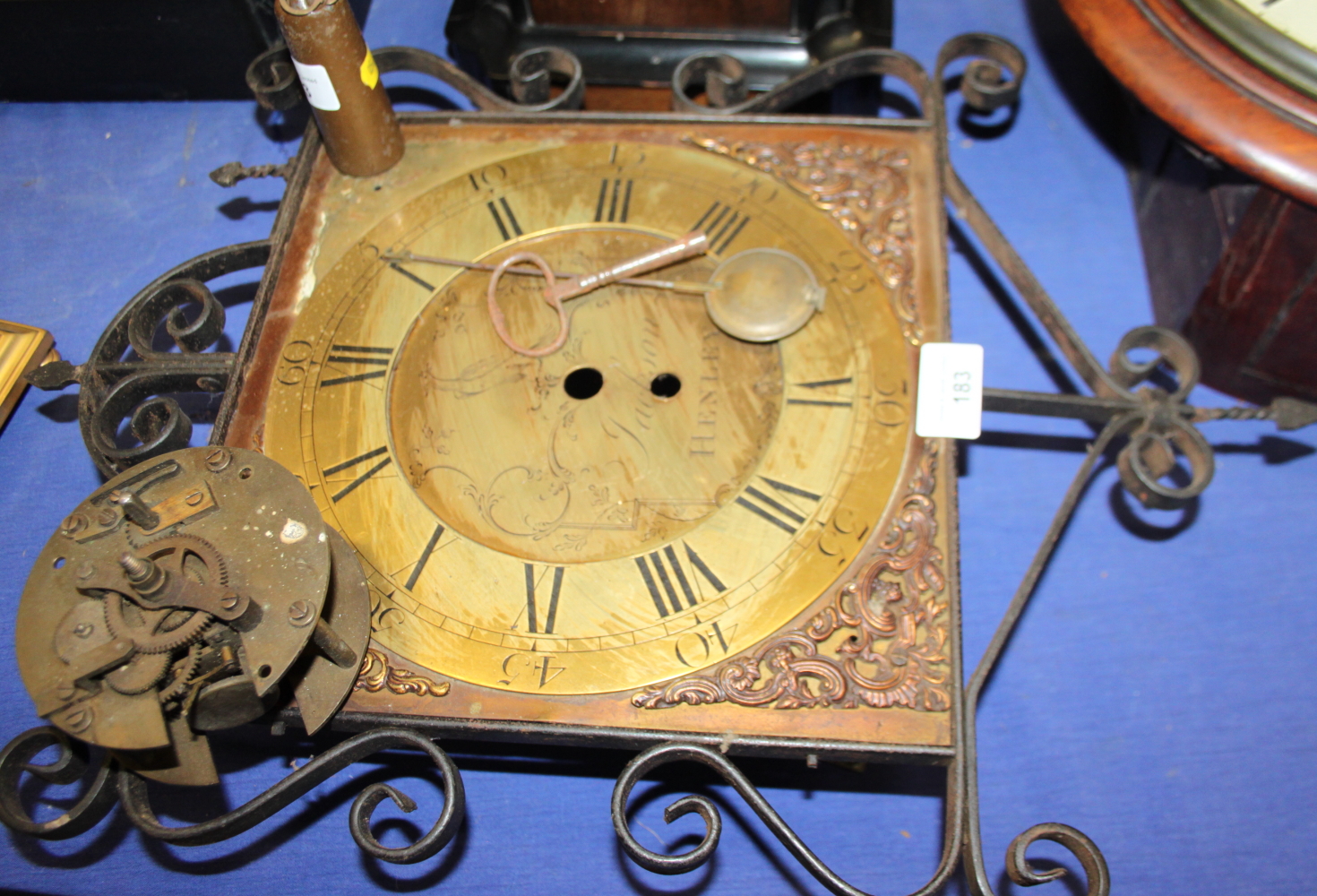 A Jackson of Henley long case clock face with gilt dial, Roman numerals with key, pendulum and