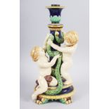 A Minton majolica candlestick with amorini, 12 1/2" high (damages)