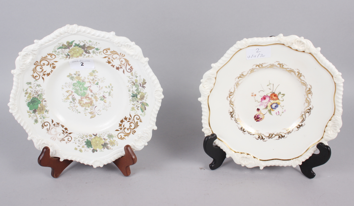 A Rockingham tureen stand, decorated ornate shell and gadroon border, centre painted floral