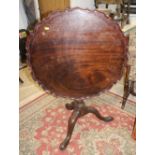 A Georgian mahogany circular pie crust tilt top table, on baluster turned column and tripod splay