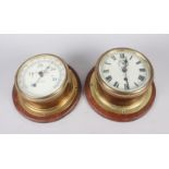 A brass cased bulkhead clock with subsidiary seconds dial and Roman numerals, 7 1/2" dia overall,