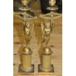 A pair of 19th century Italian gilt brass single light table candlesticks, formed as cherubs with
