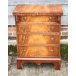 A bachelor's Bevan Funnell figured mahogany fold-over top chest, fitted three drawers, on bracket