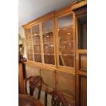 A 19th century waxed pine breakfront bookcase, the upper section enclosed glazed panelled doors over