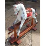 An early 20th century Ayres type carved wood rocking horse, 44" wide