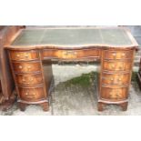A mahogany double bowfront pedestal desk, fitted nine drawers and tooled leather top, 48" wide