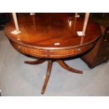A Bevan Funnell mahogany and banded extending circular dining table with two extra leaves, on turned
