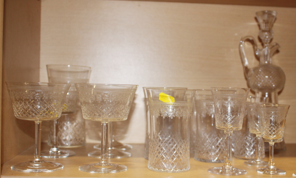 A part suite of Edwardian drinking glasses with cut and engraved decoration, and a thistle-shaped