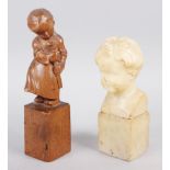 An alabaster bust of a child, indistinctly signed, 6 1/2" high, and a carved wood figure of a child,