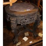 A Chinese hardwood stand with marble top and pierced and carved decoration, standing on quadruple