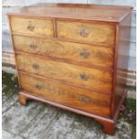 A 19th century mahogany chest of two short and three long graduated drawers with pierced handle back