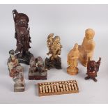 A quantity of Chinese carved figures, including a figure of Buddha and an abacus