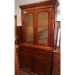 A mahogany secretaire bookcase enclosed two glazed doors over drawer and two doors, on block base,