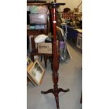 A mahogany torchere, on turned and fluted column and tripod splay supports, 59 1/2" high