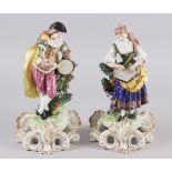 A pair of Continental "Derby" figures, musicians, on scroll work bases, 8 1/2" high (restored)