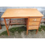 A contemporary teak single pedestal desk with three drawers, 42" wide