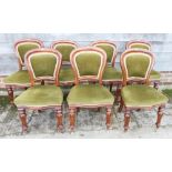 A set of seven Victorian mahogany showframe balloon back dining chairs, upholstered in a green