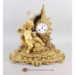 A French gilt mantel clock with white enamel dial, Roman numerals and putto, fish and shell