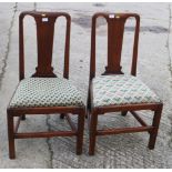 A pair of early 19th century mahogany side chairs with splat backs and drop-in needlepoint seats, on