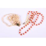 A pearl three-strand necklace with yellow metal clasp and a coral and "pearl" single strand necklace