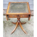 A walnut tooled leather lined flap top work table, fitted two drawers, on turned column and