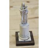 A 19th century Dieppe ivory of the Madonna and child, on circular column and square base, 6" high (
