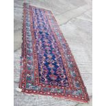 A Herati runner with geometric design on a blue ground and multi borders with shades of red and
