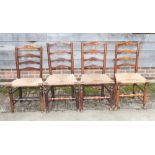A set of four 19th century ash ladder back chairs with rush envelope seats, on turned and