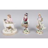 A 19th century Meissen figure of a child with a goat, on oval base, 6" high (damages), and a pair of