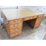 A mahogany and brass bound military style double pedestal desk with tooled lined top, fitted nine