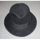 A Lincoln Bennett & Co black fedora/trilby hat, 7 3/4" x 6 1/4", and a leather briefcase
