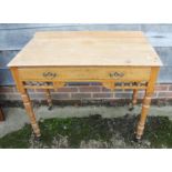 A pine side table with raised back, fitted one drawer, on turned castored supports, 36" wide