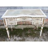 A Louis XVI design white painted and gilt inverse break front writing table, fitted five drawers, on