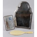 An engine turned silver framed easel mirror with shaped bevelled plate, 12" high and a silver backed