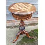 An early Victorian walnut and chess board inlaid work table, on turned and carved column and