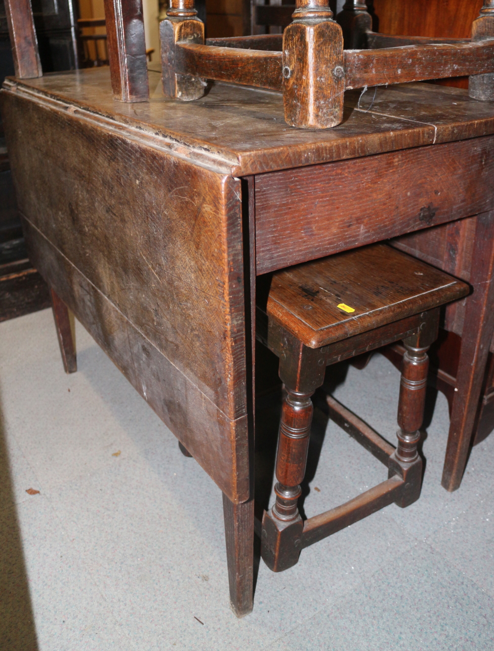 An early 20th century oak Pembroke table, on turned supports, 36" wide x 22" deep x 28" high