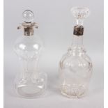 A silver mounted hourglass decanter and stopper, and a Victorian cut glass decanter with silver