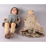 An Armand & Marseille bisque doll with sleeping eyes, closed mouth, jointed body and original