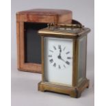 A French brass and glass cased carriage clock with travel case, 4 1/2" high