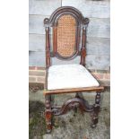 An early 18th century fruitwood and oak cane panel back side chair with drop-in seat, on turned