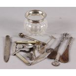 A moulded glass trinket jar with silver top, two silver handled shoe horns, two mother-of-pearl