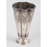 A Middle Eastern white metal fluted vase with engraved decoration, 5 1/4" high