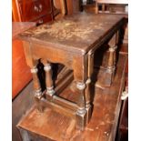 A nest of two oak tables, 21 3/4" wide, and a black and yellow dartboard design footstool, 14" dia