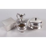 A silver plated muffin dish and cover, two plated jugs and a white metal cigarette box with cedar