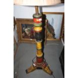 A Venetian design standard lamp with turned painted column, on triple supports