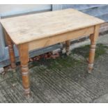 A rectangular pine kitchen table, fitted one drawer, on turned supports, 42" wide